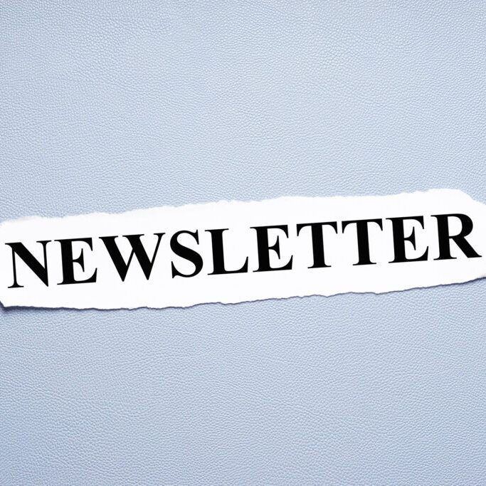 newsletter in upper case letters printed on torn piece of paper