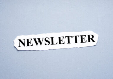 newsletter in upper case letters printed on torn piece of paper