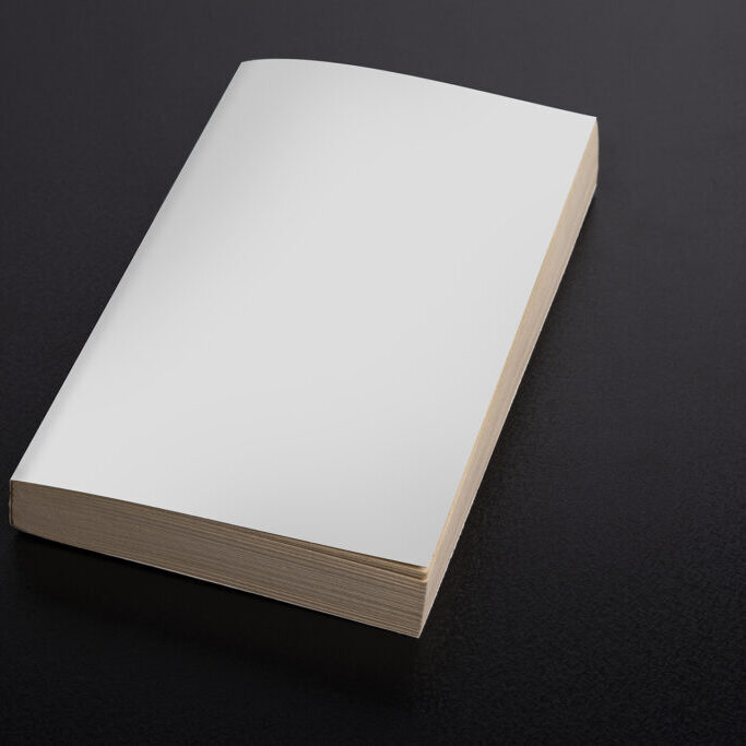 A closeup shot of a book with a blank cover on black background